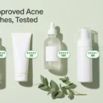 Flatlay of five unbranded acne face wash bottles with green Yuka score chips above 80 on a sage background